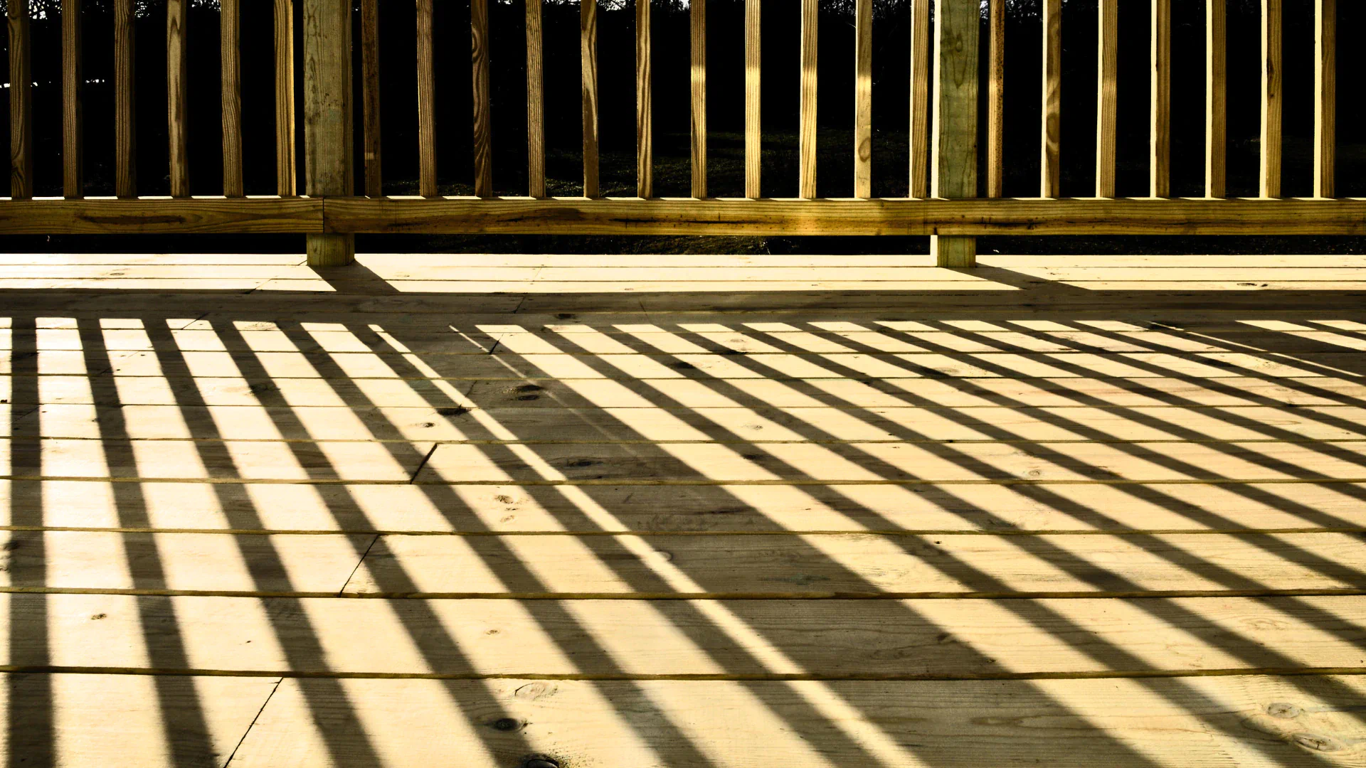 shadows being casted across the wooden deck rails seal rock or